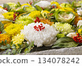 Auspicious red berries and colorful chrysanthemums floating in the water basin 134078242