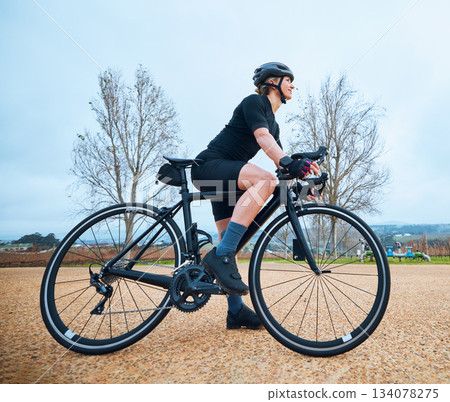 Bicycle, cycling and fitness with woman in nature for training, workout and sports cardio. Health, relax and thinking with female cyclist riding on bike for exercise, endurance and challenge Bicycle, cycling and fitness with woman in nature for training, workout and sports cardio. Health, relax and thinking with female cyclist riding on bike for exercise, endurance and challenge 134078275