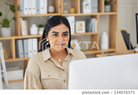 Business, digital or Indian woman typing on computer working on email or online project research. Technology, office feedback or girl journalist writing blog reports or internet articles with focus 134078373