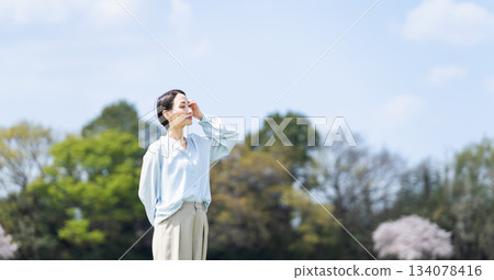 Young woman relaxing on a green hill Lifestyle image 134078416