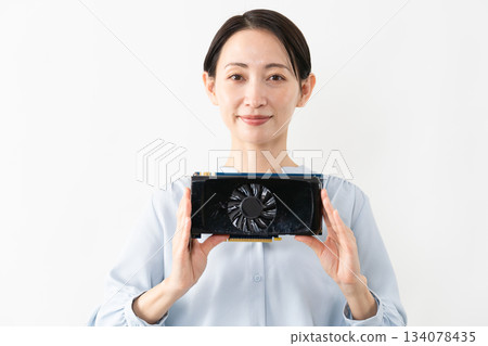 Woman holding a graphics card Technology image 134078435