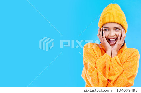 Happiness, surprised and woman hands on studio mockup ready for cold weather with winter fashion. Isolated, blue background and surprise emoji with a happy, young and gen z person with wow and smile 134078493