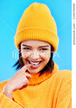 Portrait of woman in winter fashion with happy face, beanie and smile isolated on blue background. Style, happiness and gen z girl in studio backdrop, mockup and flirt, warm clothing for cold weather Portrait of woman in winter fashion with happy face, beanie and smile isolated on blue background. Style, happiness and gen z girl in studio backdrop, mockup and flirt, warm clothing for cold weather 134078499