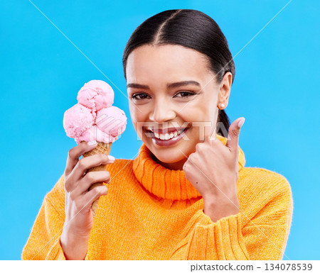 Woman, studio portrait and ice cream with thumbs up, smile and happiness by blue background. Girl, model and sweet dessert with hand sign, happy and excited for food, gelato and eating by backdrop Woman, studio portrait and ice cream with thumbs up, smile and happiness by blue background. Girl, model and sweet dessert with hand sign, happy and excited for food, gelato and eating by backdrop 134078539