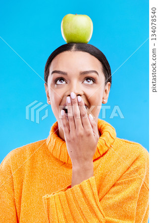 Apple head balance, woman face and surprised with fruit product for weight loss benefits, healthy lifestyle or body detox. Organic food diet, nutritionist studio and shocked person on blue background Apple head balance, woman face and surprised with fruit product for weight loss benefits, healthy lifestyle or body detox. Organic food diet, nutritionist studio and shocked person on blue background 134078540