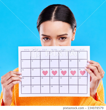 Calendar, heart and woman on blue background for period schedule, planning and menstruation in studio. Time management, strategy and eyes of girl with month poster for date, weekly planner and cycle Calendar, heart and woman on blue background for period schedule, planning and menstruation in studio. Time management, strategy and eyes of girl with month poster for date, weekly planner and cycle 134078579