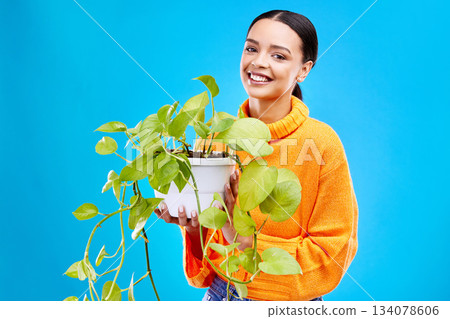Portrait of woman on blue background with plant, smile and happiness with house plants in studio. Gardening, sustainable and green hobby for happy gen z girl on mockup for eco friendly garden shop. Portrait of woman on blue background with plant, smile and happiness with house plants in studio. Gardening, sustainable and green hobby for happy gen z girl on mockup for eco friendly garden shop. 134078606