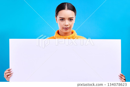 Studio, blank sign and portrait of woman with info and mockup isolated on blue background. Marketing, advertising and gen z girl with poster for product placement or news announcement mock up space. 134078623