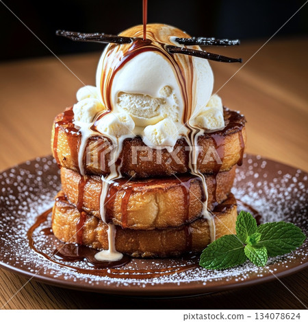 French toast with vanilla ice cream and melting caramel sauce 134078624
