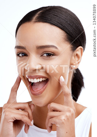Happy, gesture and portrait of a woman for beauty isolated on a white background in a studio. Smile, skincare and face of a young model looking confident about clear complexion and smooth skin Happy, gesture and portrait of a woman for beauty isolated on a white background in a studio. Smile, skincare and face of a young model looking confident about clear complexion and smooth skin 134078899
