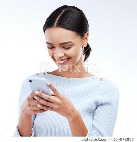 Phone, typing and happy woman isolated on a white background for social media, funny meme or internet chat. Young person networking, communication or reading news or post on mobile app in studio 134078937