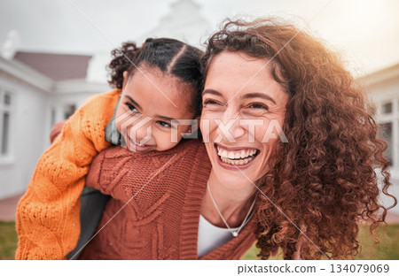 Smile, piggy back and happy woman with child in yard of new house, happiness and adoption at family home. Interracial mom and girl bonding in backyard together with love and outdoor fun on weekend. 134079069
