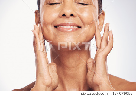 Closeup, cosmetics and mature woman with skincare, dermatology and self care against a studio background. Female, beauty and person with organic facial, face detox and treatment with grooming routine Closeup, cosmetics and mature woman with skincare, dermatology and self care against a studio background. Female, beauty and person with organic facial, face detox and treatment with grooming routine 134079093