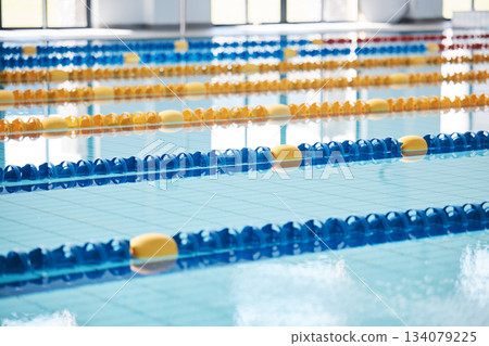 Empty, swimming pool or lines in water for race or racing lanes for fitness or underwater sports. Background, blue or gym training arena ready for cardio performance, workout or exercise challenge Empty, swimming pool or lines in water for race or racing lanes for fitness or underwater sports. Background, blue or gym training arena ready for cardio performance, workout or exercise challenge 134079225