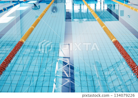 Swimming, lane and water at an indoor pool for sports, recreation and weekend fun. Empty, training and a rows for competition, sport race or practice cardio for athletes or leisure activities 134079226