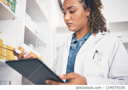 Tablet, stock and healthcare with a pharmacist woman at work to fill an online order or prescription. Medical, product and insurance with a female working as a medicine professional in a pharmacy Tablet, stock and healthcare with a pharmacist woman at work to fill an online order or prescription. Medical, product and insurance with a female working as a medicine professional in a pharmacy 134079330
