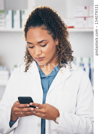 Pharmacist woman, phone and texting in store for contact, email communication or reading chat. Pharmacy, female and smartphone for social media app, typing and medical news on internet in workplace Pharmacist woman, phone and texting in store for contact, email communication or reading chat. Pharmacy, female and smartphone for social media app, typing and medical news on internet in workplace 134079331