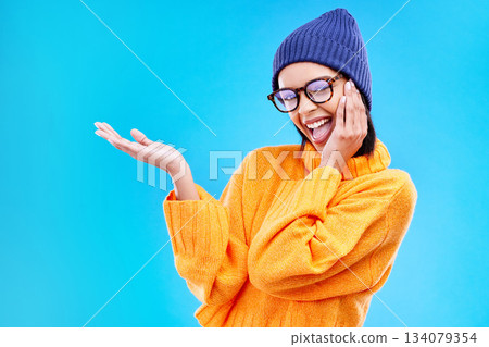 Woman palm, happiness and portrait in a studio with promotion and announcement. Excited, isolated and blue background with mockup of a gen z girl and cool young female show marketing with smile 134079354