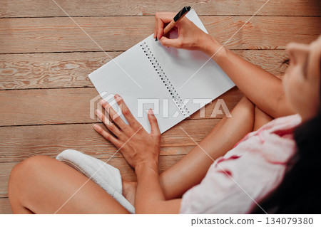 Notebook, writing and planning woman with journal for ideas, inspiration and creativity on wood floor above. Creative young person with mindfulness, healing notes and self care book for writer goals 134079380