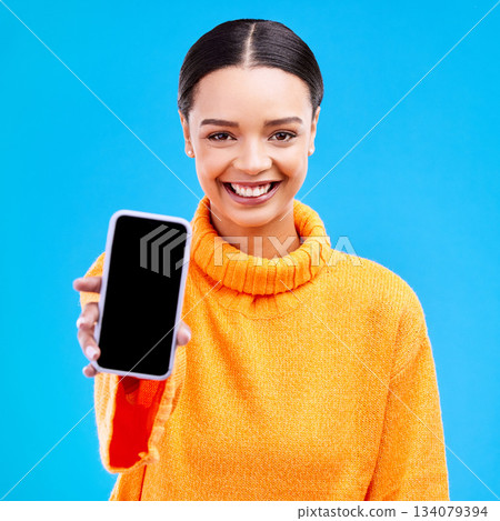 Phone, mockup and portrait of woman in studio for website, technology and social media news. Networking, internet and connection with female on blue background for app, logo and search Phone, mockup and portrait of woman in studio for website, technology and social media news. Networking, internet and connection with female on blue background for app, logo and search 134079394