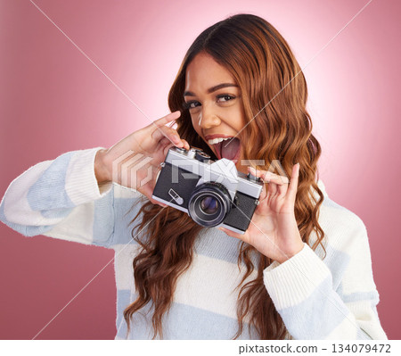 Portrait, photographer and woman in studio with camera, happy and excited while posing on pink background. Face, person and girl with lens having fun, cheerful and pose for picture or photo Portrait, photographer and woman in studio with camera, happy and excited while posing on pink background. Face, person and girl with lens having fun, cheerful and pose for picture or photo 134079472