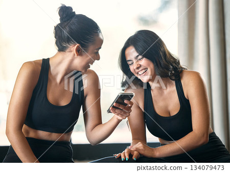 Fitness, funny and women with smartphone, exercise and fun after workout, training and friends. Female athletes, girls and partners with cellphone, meme or social media with smile, practice and break Fitness, funny and women with smartphone, exercise and fun after workout, training and friends. Female athletes, girls and partners with cellphone, meme or social media with smile, practice and break 134079473