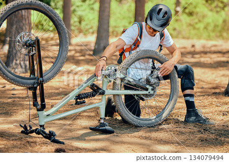 Maintenance, fitness and a man with a bicycle for cycling, fixing a wheel or tire in nature. Training, cardio and a cyclist repairing a bike, doing repairs and inspection for a race or competition Maintenance, fitness and a man with a bicycle for cycling, fixing a wheel or tire in nature. Training, cardio and a cyclist repairing a bike, doing repairs and inspection for a race or competition 134079494