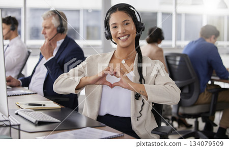 Hands, heart and portrait of happy woman in call center for customer care, excellence and sales support in office. Female consultant, gesture and love sign for telemarketing services, emoji and smile 134079509