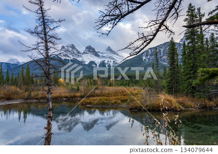 Fall reflections of the Three Sisters and Mount Lawrence Grassi in Canmore, Alberta, Canada 134079644