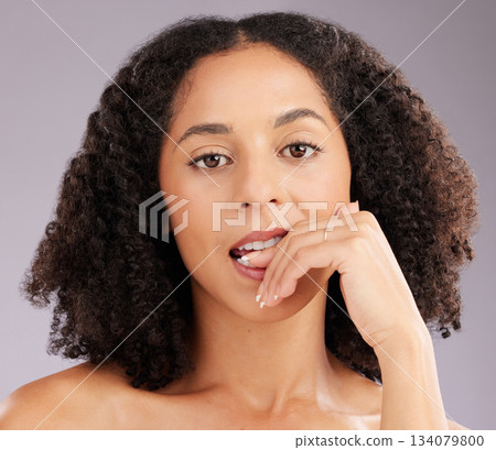 Woman, face and beauty, biting finger in portrait and flirt with hand, manicure and sexy on studio background. Makeup, natural cosmetics and flirtatious female, skincare and glow with cosmetic care 134079800