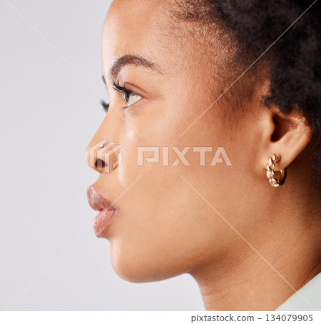 Serious, side profile and face of a black woman isolated on a white background in a studio. Focus, thinking and an African girl looking thoughtful, contemplating and taking a headshot on a backdrop 134079905