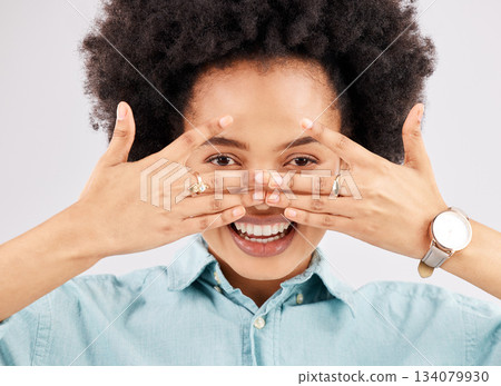 Portrait, hiding face woman and smile in a studio with a person feeling playful or joking for comedy. Eyes, smile and hand gesture with a funny young female looking happy with a positive attitude Portrait, hiding face woman and smile in a studio with a person feeling playful or joking for comedy. Eyes, smile and hand gesture with a funny young female looking happy with a positive attitude 134079930