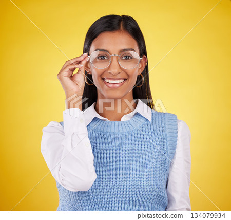 Glasses, happy and portrait of woman in studio for eyewear, vision and confidence. Optometry, nerd and happiness with female and spectacles isolated on yellow background for pride, young and eye care 134079934