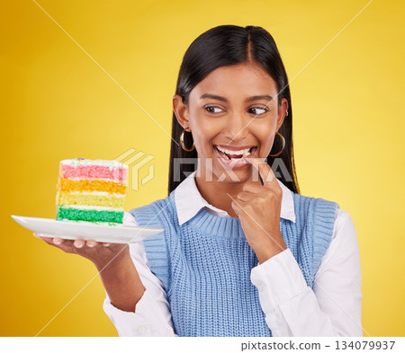 Birthday, diet and woman with cake in studio for happy celebration or party on yellow background. Happiness, excited gen z model with rainbow dessert on plate to celebrate milestone or achievement. Birthday, diet and woman with cake in studio for happy celebration or party on yellow background. Happiness, excited gen z model with rainbow dessert on plate to celebrate milestone or achievement. 134079937