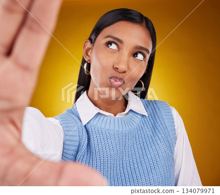 Selfie, happy woman and kiss in studio isolated on a brown background or backdrop. Thinking, idea and Indian person taking photo for memory, social media or profile picture for photography pout. 134079971