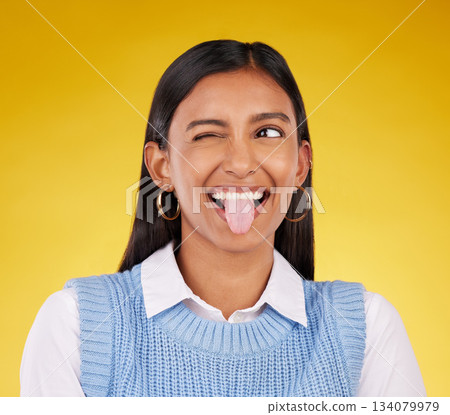Funny, emoji and woman with tongue out, happy and cheerful against a studio background. Female, stress relief and girl with facial expression, humor and goofy action for joy, crazy and happiness Funny, emoji and woman with tongue out, happy and cheerful against a studio background. Female, stress relief and girl with facial expression, humor and goofy action for joy, crazy and happiness 134079979