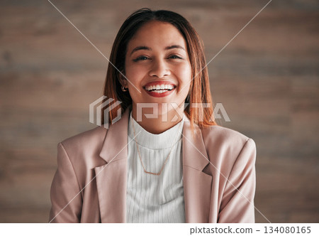 Portrait, happy and a business woman on a wooden background in studio with a positive mindset. Face, smile and motivation with a carefree young female employee feeling cheerful for a corporate career Portrait, happy and a business woman on a wooden background in studio with a positive mindset. Face, smile and motivation with a carefree young female employee feeling cheerful for a corporate career 134080165