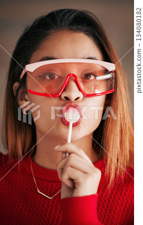Portrait, fashion and woman with lollipop, glasses and confidence with stylish outfit, edgy and trendy. Face, female and lady with sweets, candy and funky eyewear with cool clothes and creativity Portrait, fashion and woman with lollipop, glasses and confidence with stylish outfit, edgy and trendy. Face, female and lady with sweets, candy and funky eyewear with cool clothes and creativity 134080182