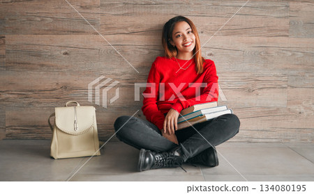University, portrait of woman with books and smile on floor, education at college on wall background mockup. Information, knowledge and space, student with backpack and happiness with book to study. University, portrait of woman with books and smile on floor, education at college on wall background mockup. Information, knowledge and space, student with backpack and happiness with book to study. 134080195