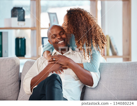 Love, happy and couple kiss on sofa for bonding, quality time and relaxing together at home. Marriage, interracial relationship and man and woman on couch embrace, hugging and laughing in living room Love, happy and couple kiss on sofa for bonding, quality time and relaxing together at home. Marriage, interracial relationship and man and woman on couch embrace, hugging and laughing in living room 134080224