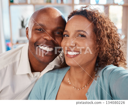Selfie, happy and portrait of couple in home for bonding, quality time and relax together in living room. Love, relationship and interracial man and woman smile for picture for social media or memory Selfie, happy and portrait of couple in home for bonding, quality time and relax together in living room. Love, relationship and interracial man and woman smile for picture for social media or memory 134080226