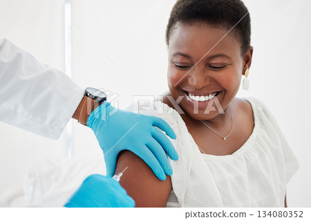 Doctor, black woman and vaccine injection with smile for safety, immunity and prevention. Covid, healthcare and medical professional with vaccination, cure or medicine for happy patient in clinic. 134080352