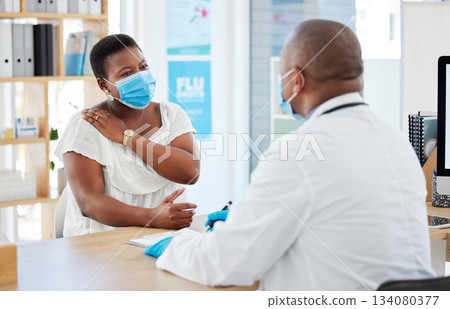 Doctor, covid and patient with shoulder pain in hospital, fibromyalgia or inflammation. Face mask, healthcare professional and black woman with injury, arthritis or painful tendinitis in consultation Doctor, covid and patient with shoulder pain in hospital, fibromyalgia or inflammation. Face mask, healthcare professional and black woman with injury, arthritis or painful tendinitis in consultation 134080377