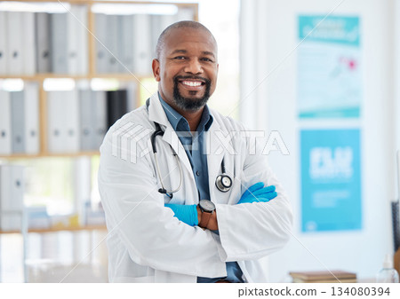 Portrait, doctor smile and black man with arms crossed, pride for career, occupation or job in clinic. Healthcare, mature person and happiness, proud and confident medical professional from Nigeria. Portrait, doctor smile and black man with arms crossed, pride for career, occupation or job in clinic. Healthcare, mature person and happiness, proud and confident medical professional from Nigeria. 134080394