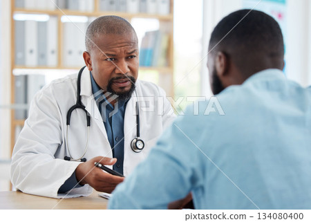 Doctor, serious black man and patient consultation in hospital for talking, checkup or results. Healthcare, medical professional and African person consulting physician for advice or cancer diagnosis 134080400