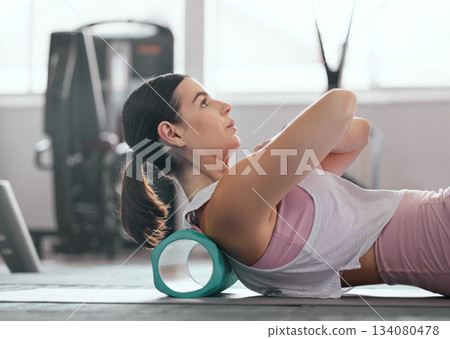 Foam roller, gym and woman doing back stretching for fitness, relief and training. Yoga, flexibility and wellness of a female doing pilates and physiotherapy for sport and breathing balance at a club Foam roller, gym and woman doing back stretching for fitness, relief and training. Yoga, flexibility and wellness of a female doing pilates and physiotherapy for sport and breathing balance at a club 134080478