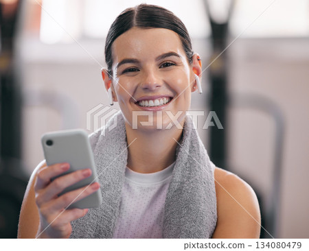 Gym, relax and portrait of happy woman with phone and headphones on workout break checking social media. Exercise, rest and person with smartphone for fitness app, music or networking for motivation. Gym, relax and portrait of happy woman with phone and headphones on workout break checking social media. Exercise, rest and person with smartphone for fitness app, music or networking for motivation. 134080479