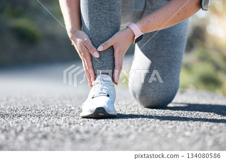 Running, fitness and ankle injury with a woman on the street during a cardio or endurance workout. Medical, pain and accident with a female runner outdoor on a road for health, sports or training Running, fitness and ankle injury with a woman on the street during a cardio or endurance workout. Medical, pain and accident with a female runner outdoor on a road for health, sports or training 134080586