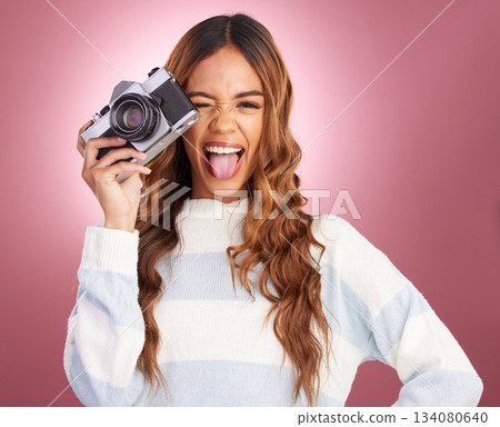 Photographer, camera and face of woman with tongue out in studio for fun, gen z and retro aesthetic on pink background. Lens, photography and portrait of girl with picture, emoji and isolated mockup Photographer, camera and face of woman with tongue out in studio for fun, gen z and retro aesthetic on pink background. Lens, photography and portrait of girl with picture, emoji and isolated mockup 134080640