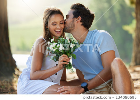 Man kiss woman, picnic with flowers in park with happy couple in nature, love with bonding and relax outdoor. Commitment, trust and relationship, people smile with summer and holiday with travel Man kiss woman, picnic with flowers in park with happy couple in nature, love with bonding and relax outdoor. Commitment, trust and relationship, people smile with summer and holiday with travel 134080693
